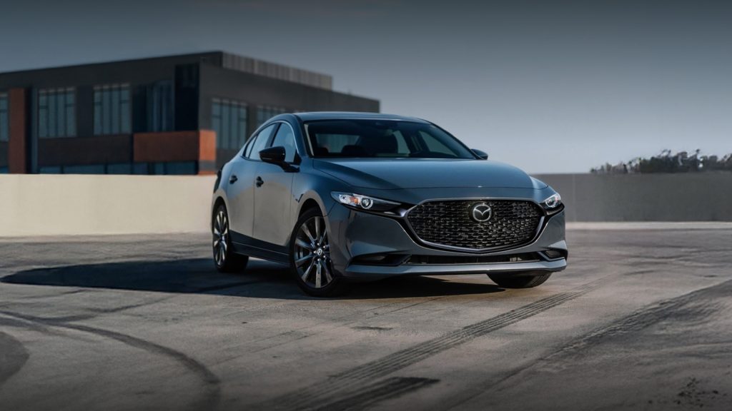 mazda3 sedan parked on a road